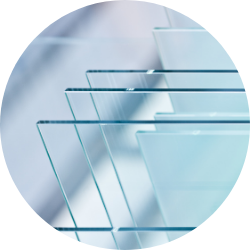 Stack of Clear Float Glass Sheets Multiple clear float glass panels arranged in a staggered stack, showcasing their thin, transparent structure and polished edges used in window manufacturing.
