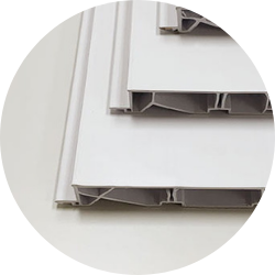 Cross-Section of Multi-Chambered Vinyl Window Frame Close-up image showing cross-sections of white vinyl window frame profiles with visible multi-chambered internal structures, designed for strength and insulation.