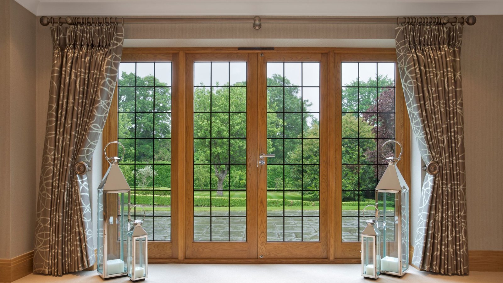 Elegant wooden French patio doors with grid glass design and outdoor garden view, example for homeowners researching how to choose patio doors in Ontario.