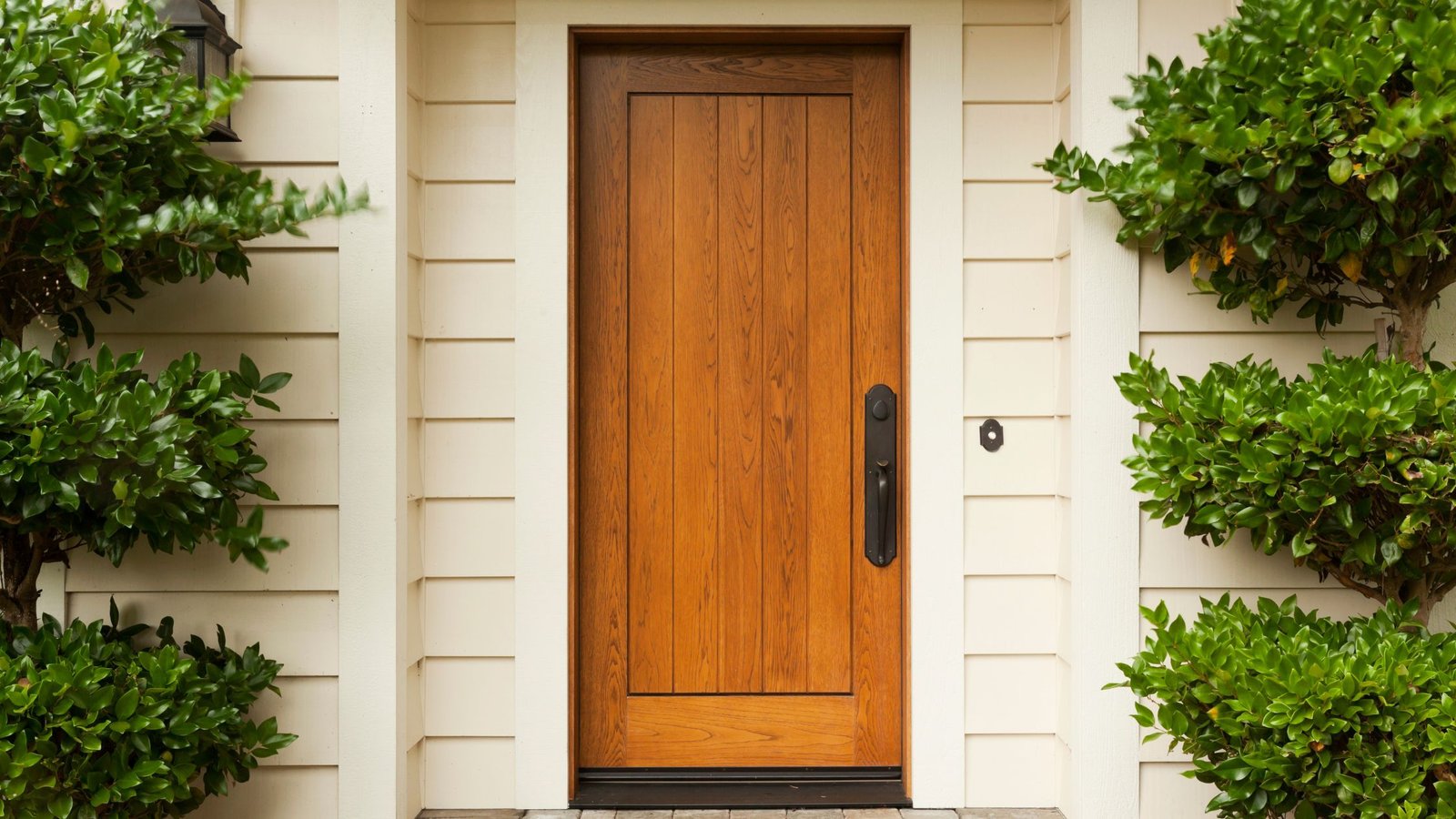 Front entry view showing a traditional wooden door on a home exterior, illustrating the benefits of replacing old wooden doors in Vaughan for better efficiency and curb appeal.