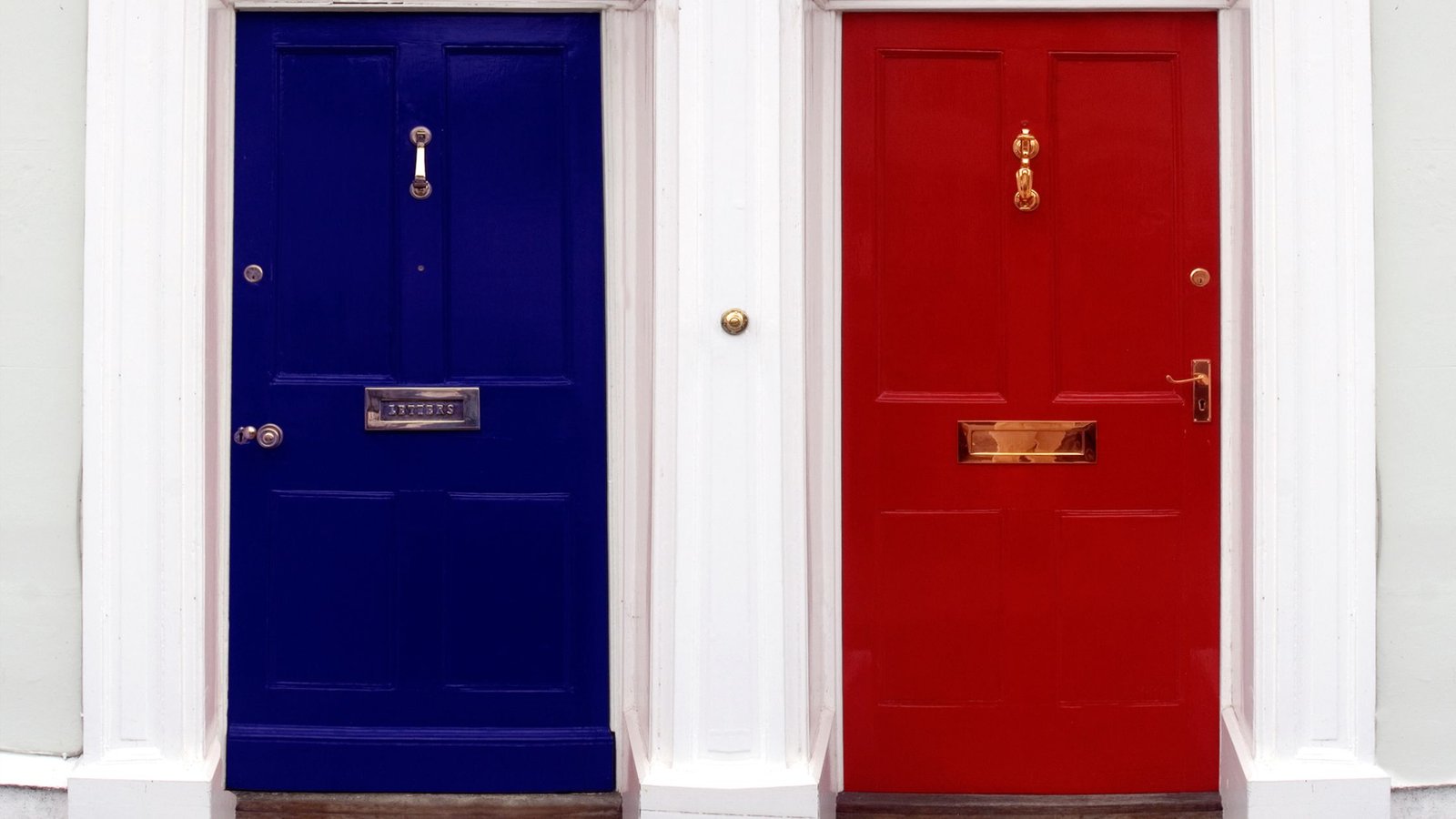 Blue and red front entry doors side by side, showcasing stylish front door options for Vaughan homes focused on design, security, and curb appeal.