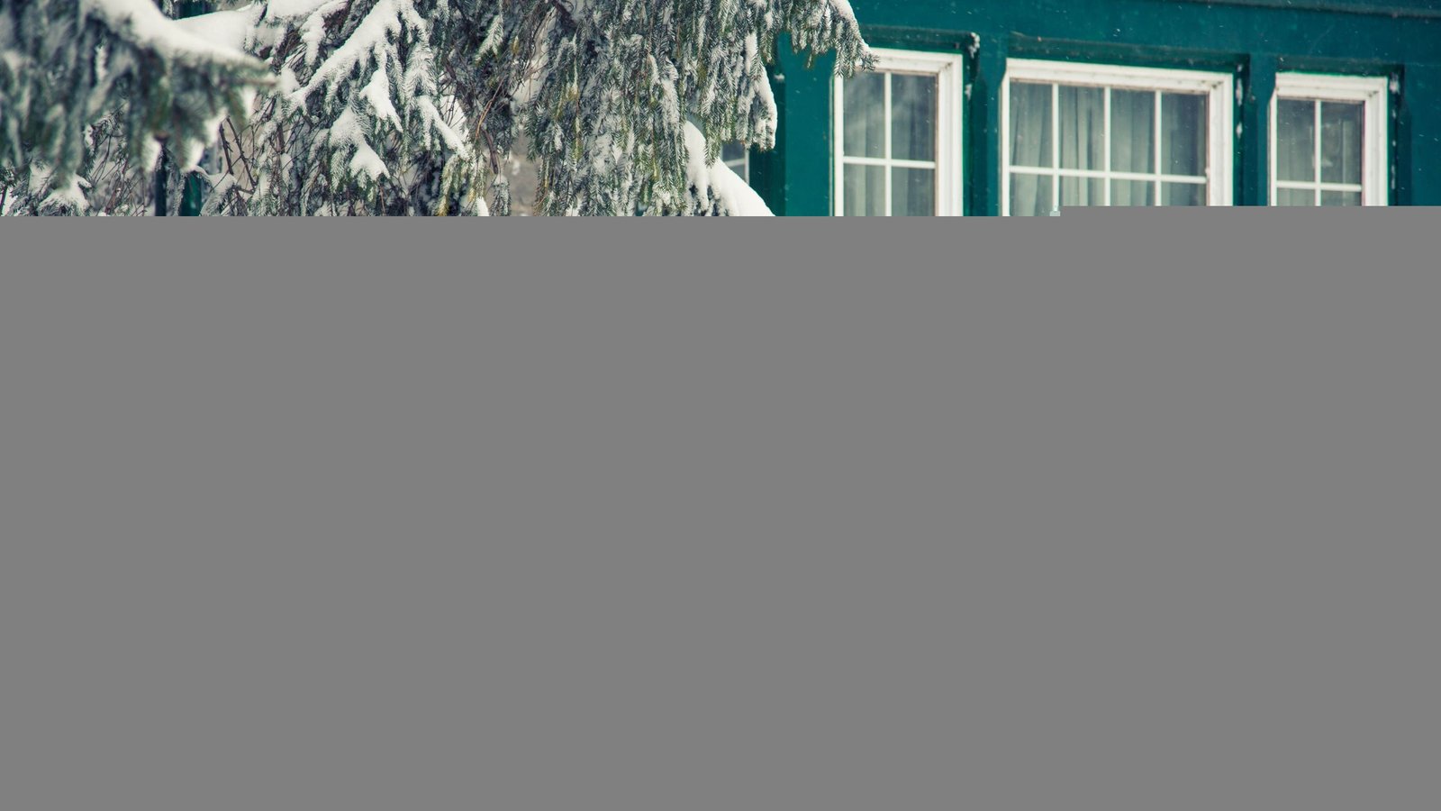Snow-covered exterior of a Vaughan home with energy-efficient window styles for maximum insulation, designed to prevent drafts and retain heat.