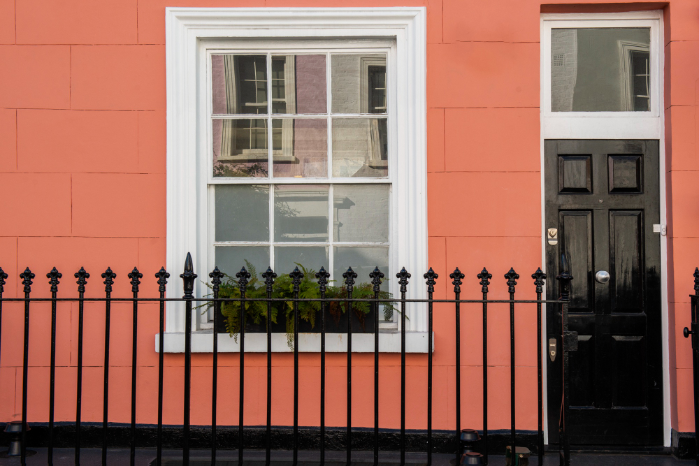 Traditional single-hung window with colonial grille – ideal replacement windows for heritage homes in Toronto. Single-hung window with colonial grilles and planter box on a heritage-style home in Toronto, paired with a black entry door for enhanced curb appeal.